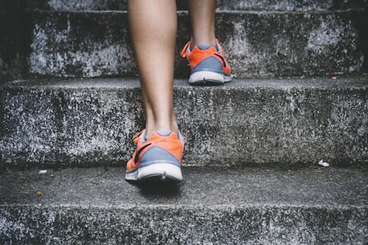 Woman walking up outdoor stairs